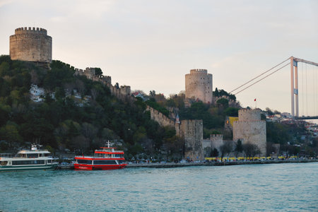 Istanbul, Turkey - December 10, 2023: Rumeli Hisari fortress and the Fatih Sultan Mehmet Bridge on the Bosphorus on the Bosphorus at sunsetのeditorial素材
