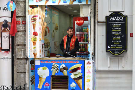 Istanbul, Turkey - December 10, 2023: An ice cream seller, dressed in traditional Turkish costume,...