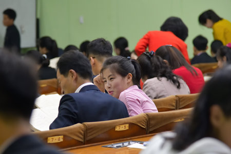 Pyongyang, North Korea - April 29, 2019: Students in the classroom of the Great People's Study House. Girl student flirts with a manのeditorial素材