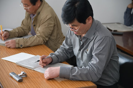 Pyongyang, North Korea - April 29, 2019: Mature student in the classroom of the Great People's Study Houseのeditorial素材