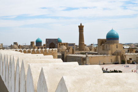 View on of Bukhara with Po-i-Kalan architectural complex and Kalyan minaret from medieval Ark fortess, Uzbekistan. Selective focus on fortress wallの写真素材
