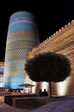 Khiva, Uzbekistan - Sept 14, 2024: Kalta Minor minaret at Muhammad Amin Khan Madrassah. Large blue minaret decorated with ornamented belts of glazed tileの写真素材
