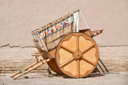 Traditional uzbek cart arba in front of ancient wall. Khiva. Uzbekistan