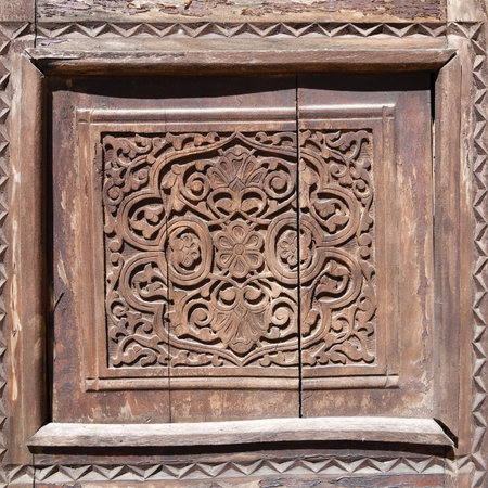 Detail of beautiful ancient carved wooden door, Shahrisabz, Uzbekistanの写真素材