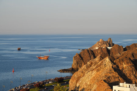 Muscat, Oman - April 01, 2025: Gulf of Oman, dhows and Mutrah Corniche view from the Mutrah Fort in...