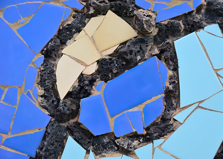 Pieces of tiles of different patterns and bright colors on basalt lava stones forming abstract figures. Lanzarote, Canary islands, Spainの写真素材