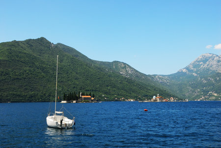 A yacht and a view of the islands in the Bay of Kotor, Montenegro.