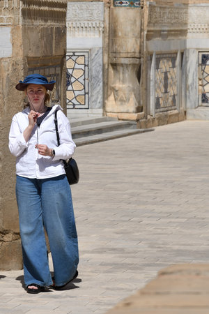 Young girl tourist portrait in Bibi-Khanym Mosque courtyard in Samarkand, Uzbekistanの写真素材