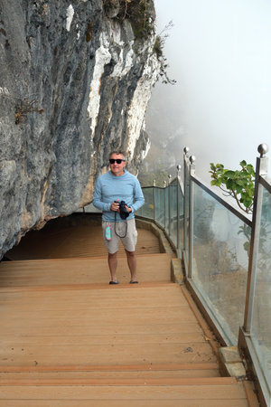 Tourist man on view point. The scenery is breathtaking rugged mountains on one side and the powerful Arabian Sea on the otherの写真素材