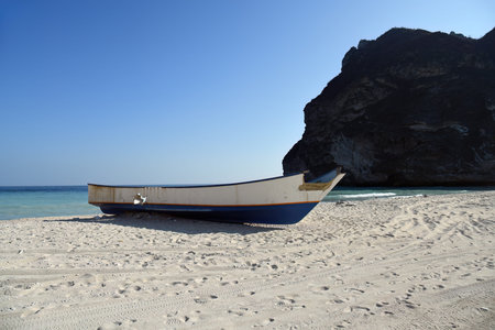 Abandoned fishing boat on Afoul Beach. This is one of Oman's fascinating beaches hidden among the high mountains. Governorate of Dhofarの写真素材