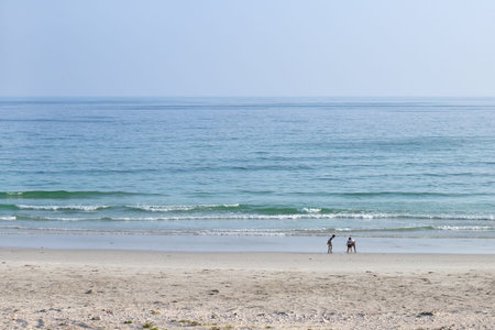 Al Mughsail Beach. Local children plaing on Arabian sea coast. Governorate of Dhofar. Salalah. Oman.の写真素材
