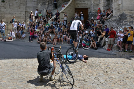 Avignon, France - July 12, 2014: Unidentified actors perform a show with bikes on the street during the annual Avignon Theater Festivalのeditorial素材