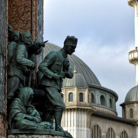 Istanbul, Turkey - December 10, 2023: Detail of Republic Monument with Ataturk figure and Taksim Mosque or Taksim Camii on background. Taksim squareのeditorial素材