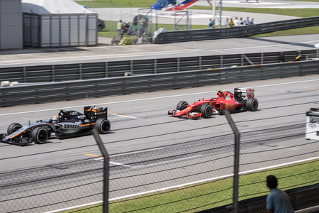 SEPANG  MARCH 29: Kimi Raikkonen of Scuderia Ferrari Versus Sergio Perez of Sahara Force India F1 Team at 2015 Formula 1 Petronas Malaysia Grand Prix Race Day at Sepang circuit on March 29 2015 in Sepang Malaysia.のeditorial素材
