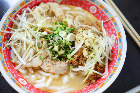 Noodles stewed bone pork with pork chaashu and pork fried sesami oilの写真素材