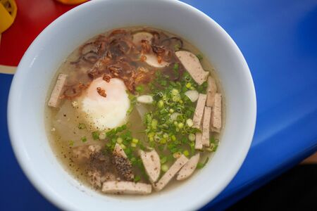 Stock Photo - Vietnamese Rice Noodle pork sausage soup with boiled egg pepper and fried onion