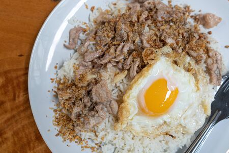 Stock Photo - Fried pork with garlic over rice peper with fried eggの写真素材