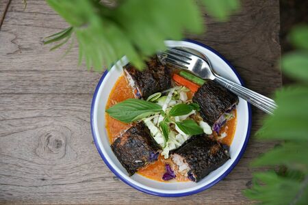 Thai style fusion Thai Rice Noodles in Fish Curry Sauce with Spicy tuna roll sushi mix with chefの写真素材