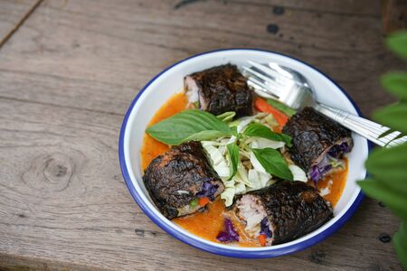 Thai style fusion Thai Rice Noodles in Fish Curry Sauce with Spicy tuna roll sushi mix with chefの写真素材