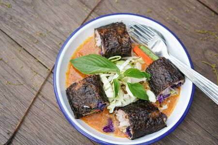 Thai style fusion Thai Rice Noodles in Fish Curry Sauce with Spicy tuna roll sushi mix with chefの写真素材