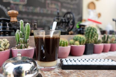 Close up black coffee on old table with abacus and cactus drink before thinkの写真素材
