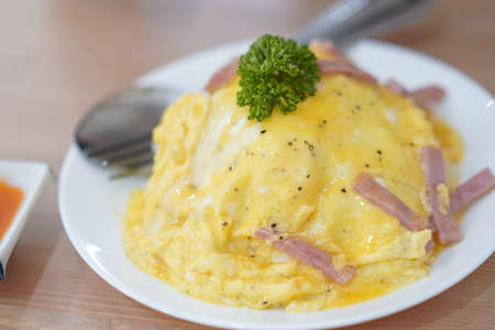 Creamy Omelet with Bacon on Rice served ready to eat selective focus and parsley topping