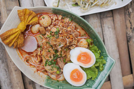 Thin rice noodles in Hot and Sour Soup added Pork balls, Sliced pork, pork liver sprinkle Serve with basil and bean sprouts.の写真素材