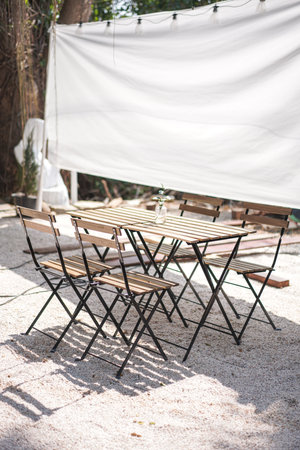 Wooden Table with Four Chairs prepare for dinner.の写真素材