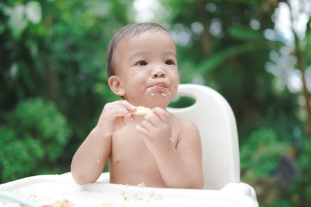 A Little baby eating dinner and making a mess selective focus.の写真素材