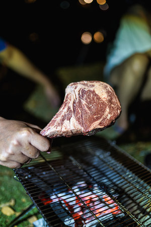 Beef Tomahawk steak on the grill with smoke and flames.の写真素材