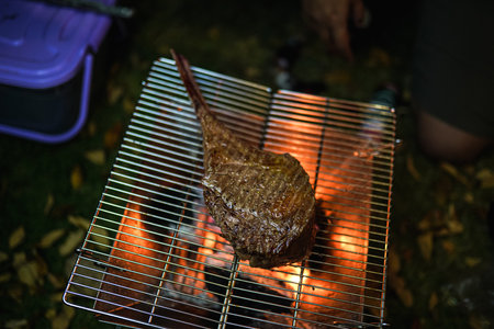 Beef Tomahawk steak on the grill with smoke and flames.の写真素材