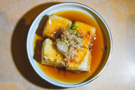 fried soft tofu with sauce in a dish.の写真素材