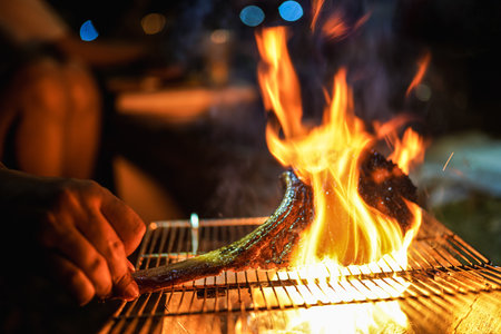 Beef Tomahawk steak on the grill with smoke and flames selective focus.の写真素材