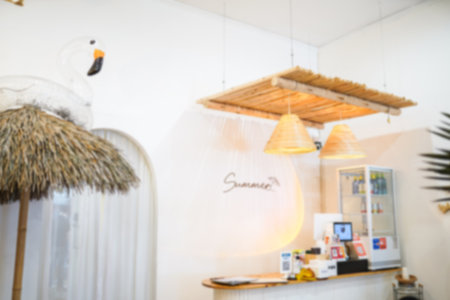 Blur background POS sale terminal machine on wooden table with cups on shelf by white wall in background.の写真素材