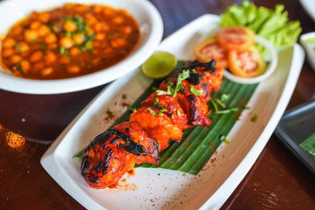 Indian chicken tikka kebabs, marinated in spices and yogurt and roasted in tandoor. served with green chutney and onion. selective focus.の写真素材