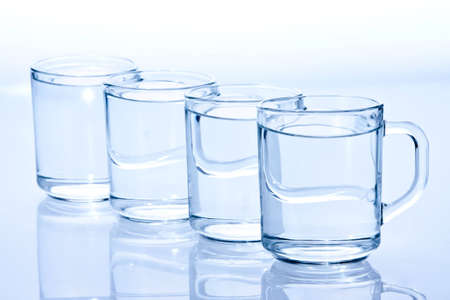 four water-filled blue glassの写真素材