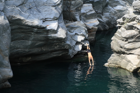 Man diving in the river of Valle Maggia の写真素材