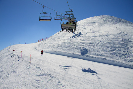 Skiers on chairlift - Paganellaの写真素材