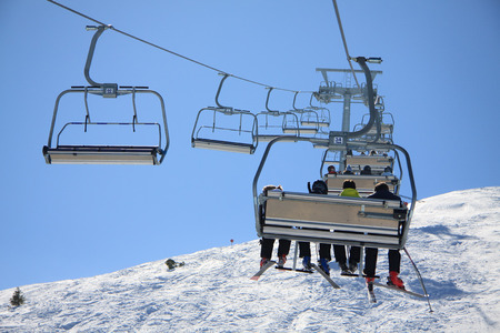 Skiers on chairlift - Paganellaの写真素材