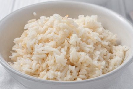 a close up of a a bowl of rice cooked in chicken stockの写真素材