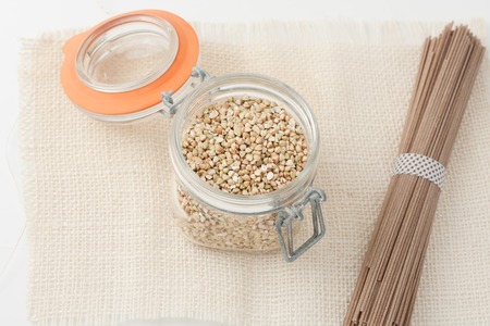 raw unroasted buckwheat groats and japanese soba noodlesの写真素材