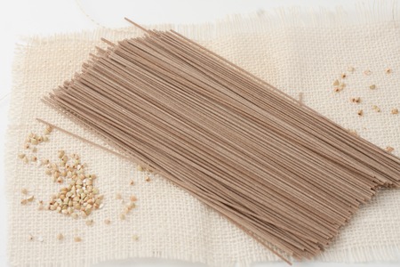 bundle of Japanese soba noodle with buckwheat groats scatteredの写真素材