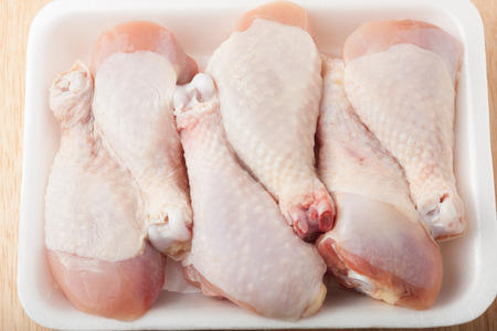 uncooked chicken drumsticks isolated in white packaging, top viewの写真素材