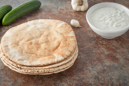 a stack of flat pita breads on textured stone backgroundの写真素材