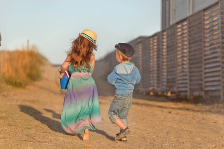 brother and sister going to the beach together while on vacationの写真素材