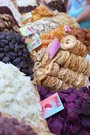 a pile of dried natural pineapple slices among other dried fruit at outdoor market, short depth of fieldの写真素材