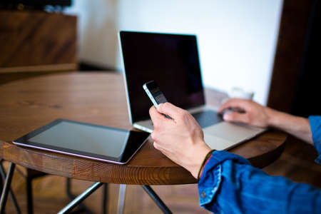 Man professional freelance content writer reading on mobile phone notification, sitting in coffee...