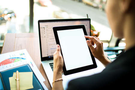 Successful businesswoman using touch pad with empty copy space screen background for promotional content. Financier online payment via digital tablet with white blank monitor. CEO using web sitesの写真素材