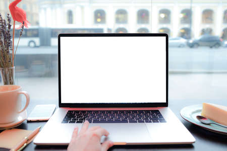 Closely woman skilled copywriter touching trackpad of modern laptop computer with empty mock up copy space screen background for advertising text message while sitting in coffee shop during recreationの写真素材