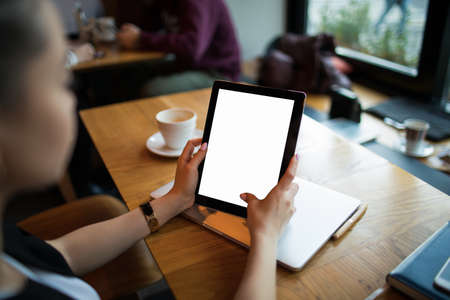 Business woman using portable touch pad with empty mock up copy space screen background for...